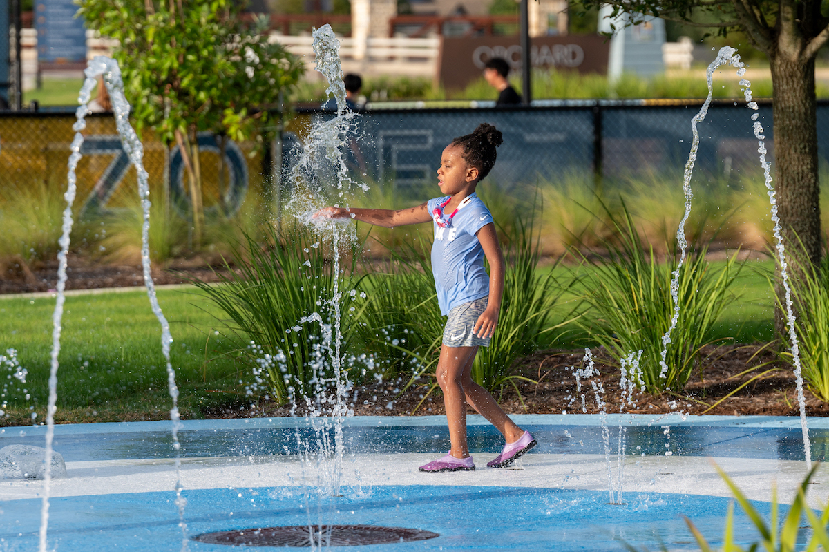 Pomona resident enjoying the splash pad at The Zone.