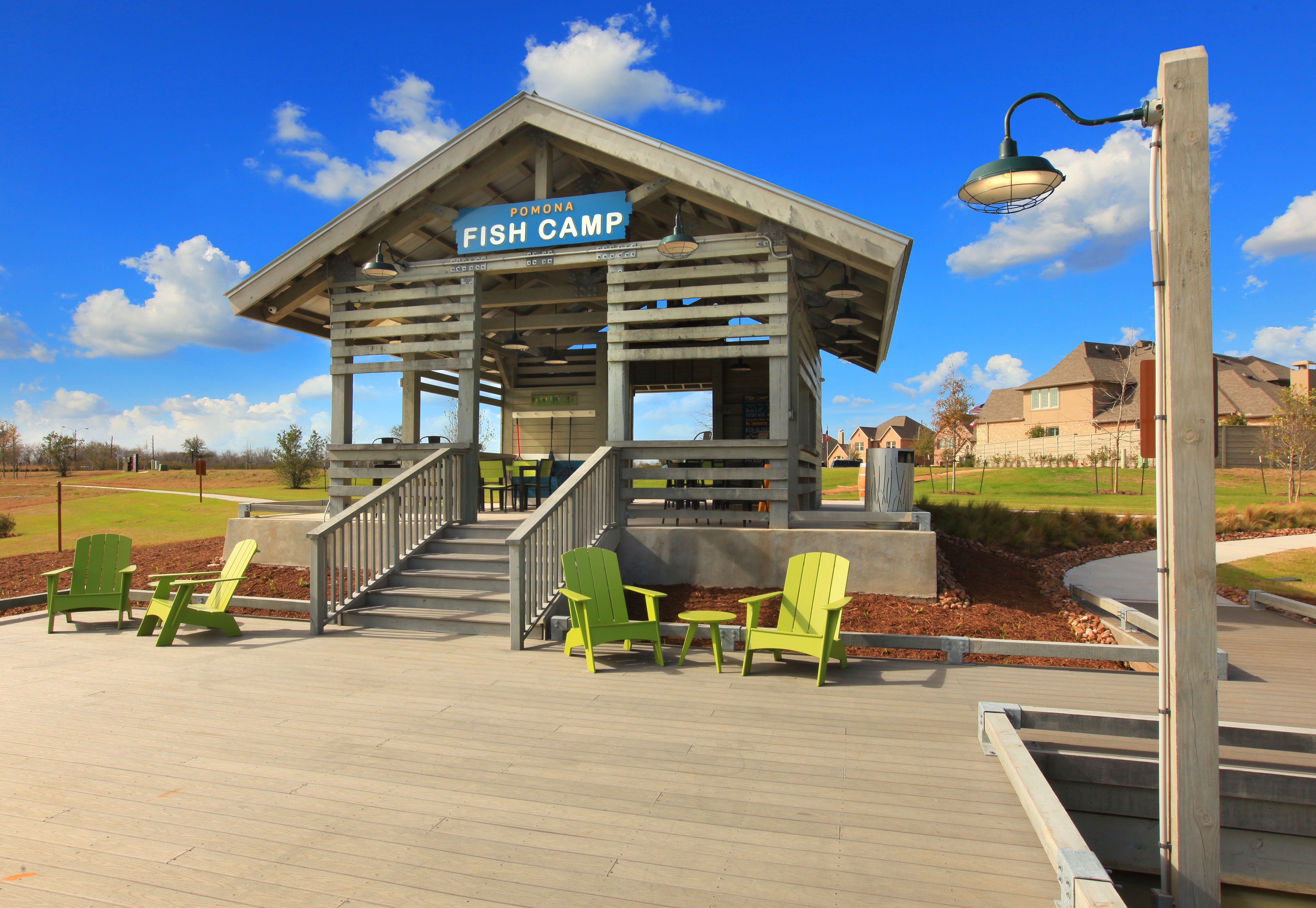 Pomona Fish camp amenity with fishing dock, deck chairs, and man-made lake system Pomona Fish camp amenity with fishing dock, deck chairs, and man-made lake system