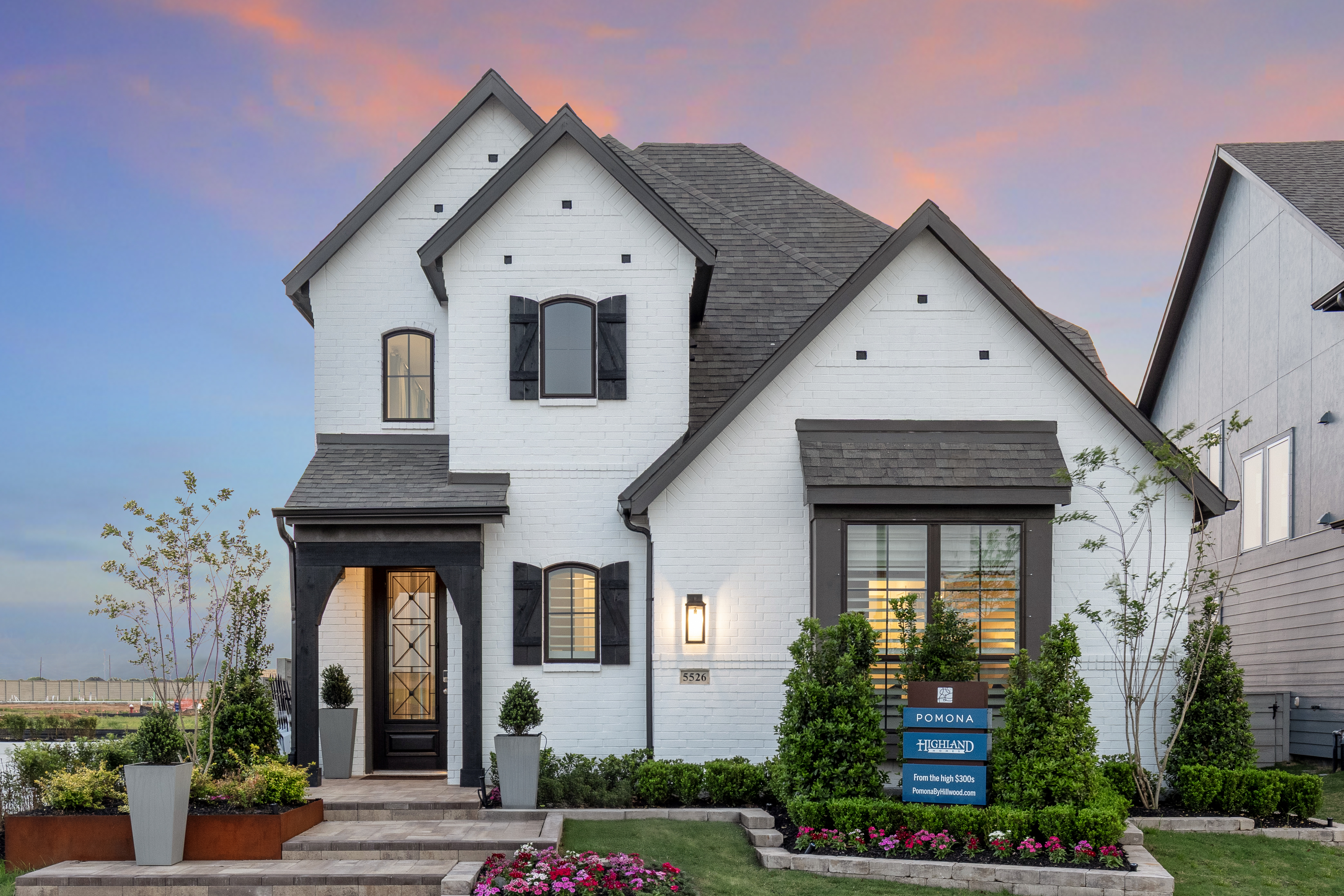 Pomona single family home with curated front yard garden against a sunset backdrop. Pomona single family home with curated front yard garden against a sunset backdrop.