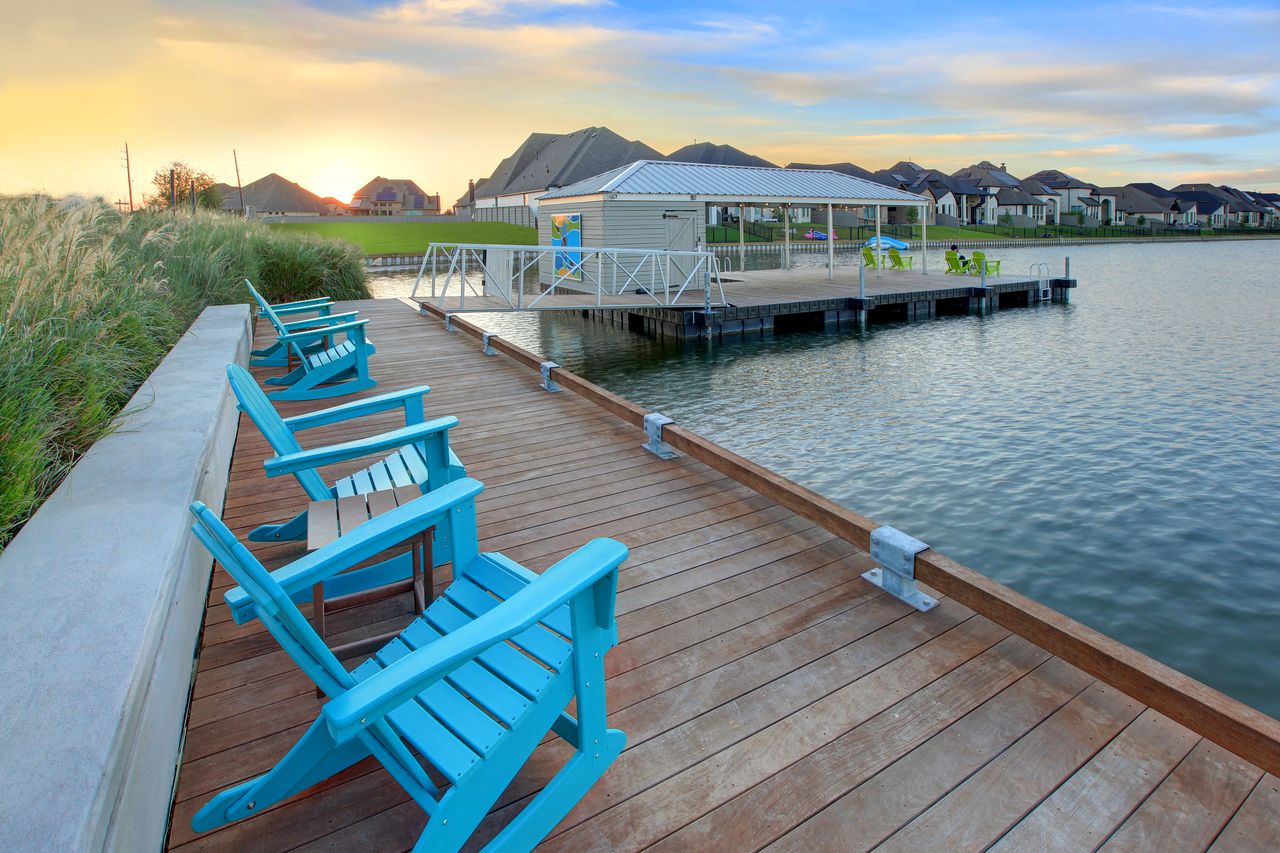 Dock amenity at Pomona with blue pool chairs along a man-made fishing lake Dock amenity at Pomona with blue pool chairs along a man-made fishing lake